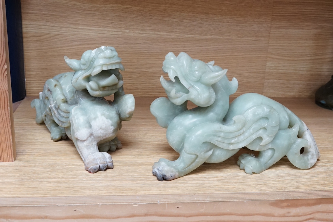 A pair of carved Chinese bowenite jade dragons, 28cm wide. Condition - fair